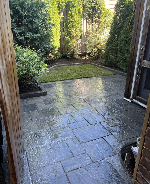 backyard with wooden fence deck stone and grass