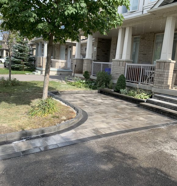 front yard and driveway covered with new stone work